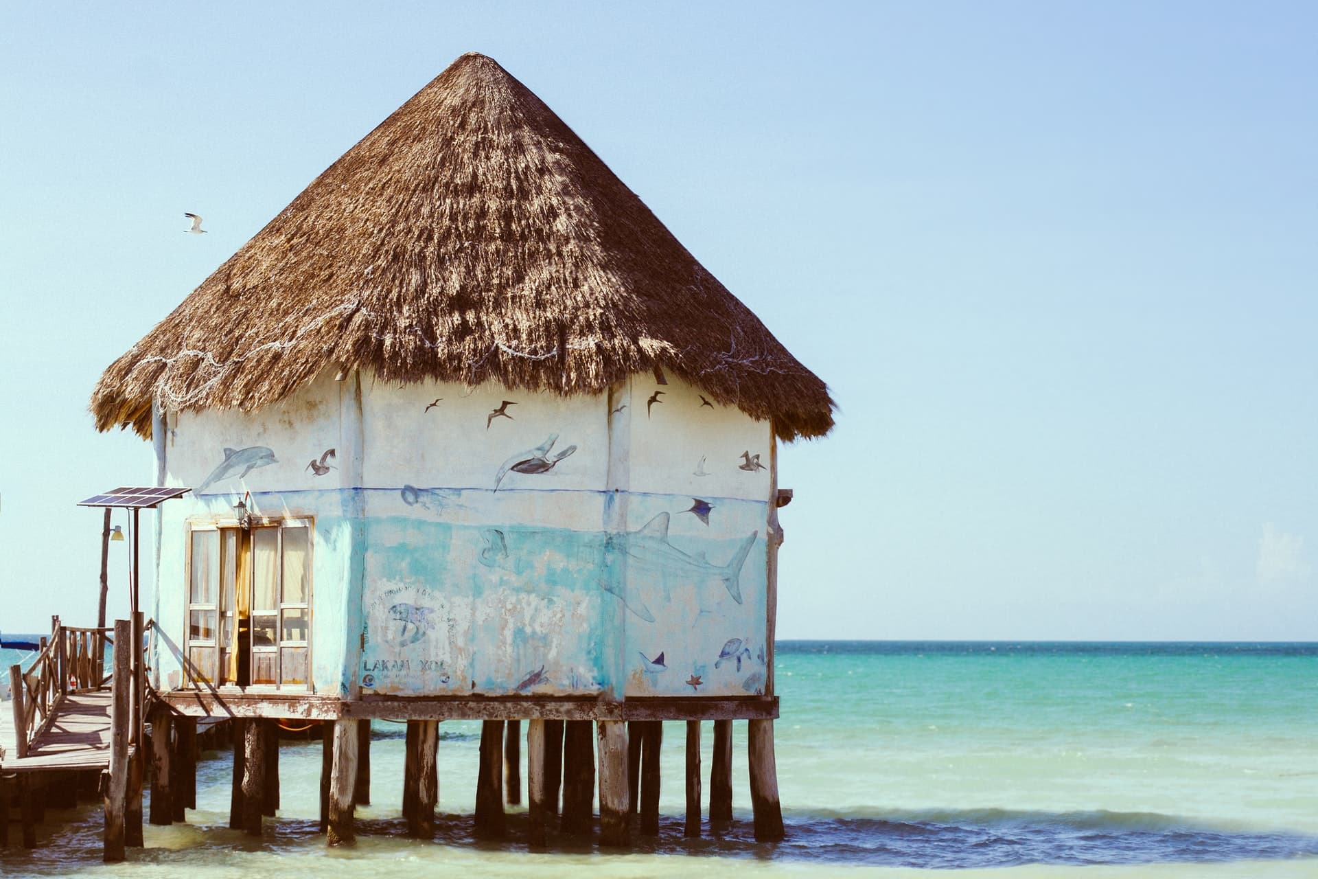 View of a cabin on the side of teal sea