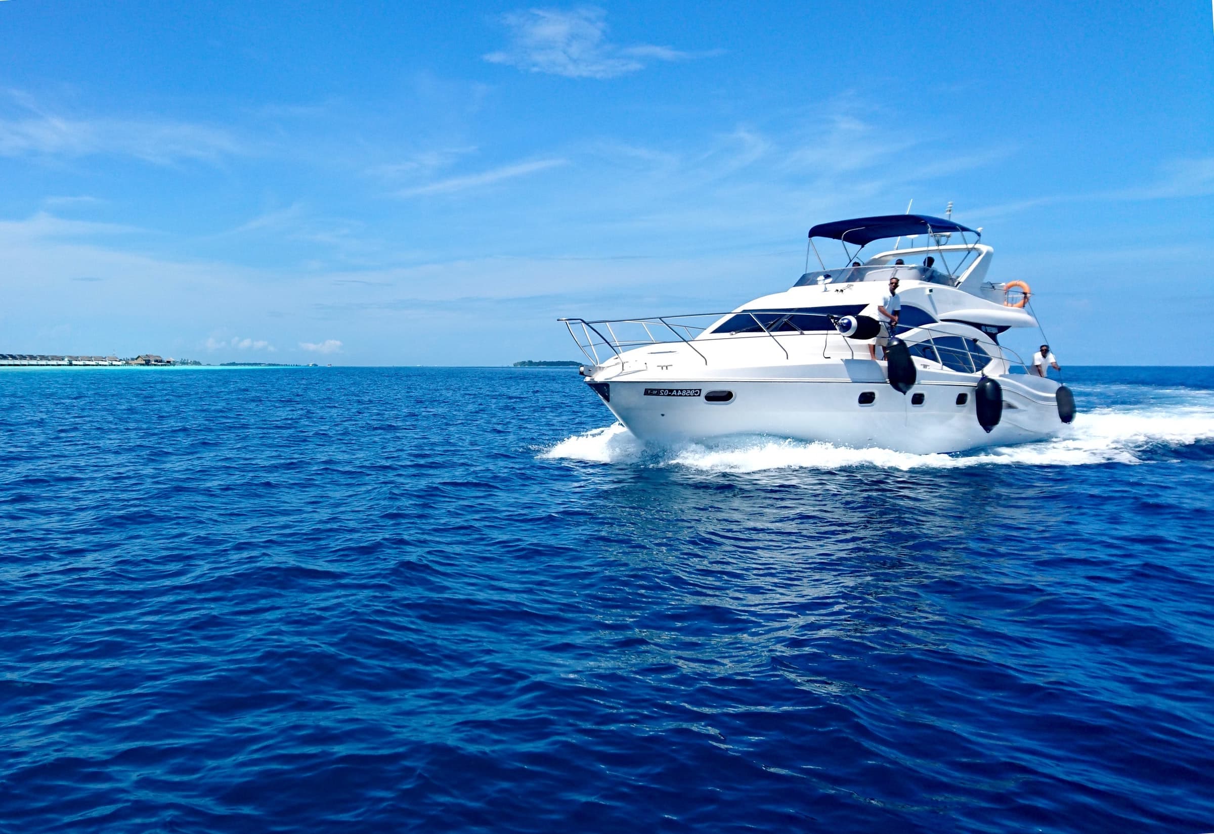 People sailing on a white yacht in the sea